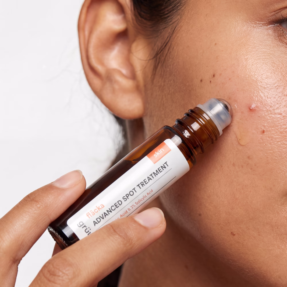 Applying spot treatment to skin blemish.