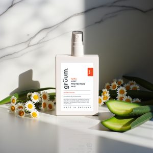 Hair mist bottle with daisies and aloe.