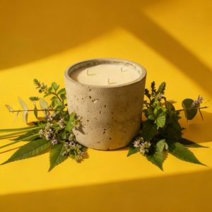 Candle in concrete holder with leaves