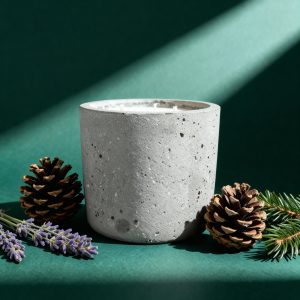 Concrete candle surrounded by pine cones, lavender.