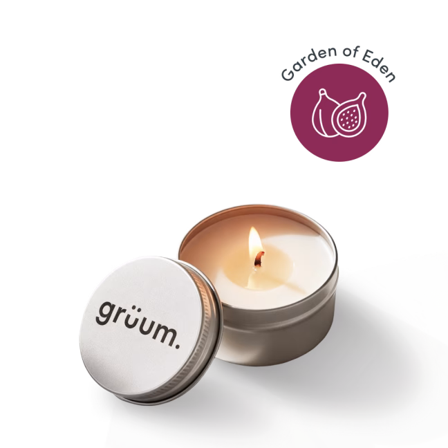 Lit candle in tin with lid