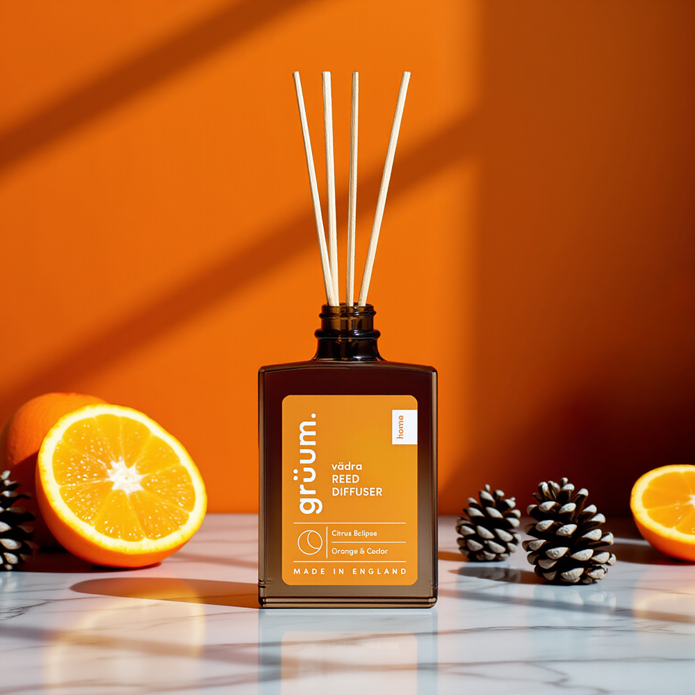 Reed diffuser with oranges and pine cones