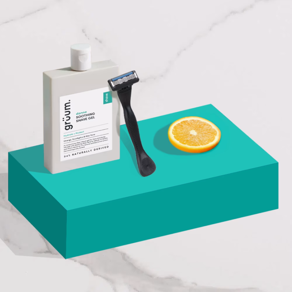 Shaving gel, razor, orange slice displayed