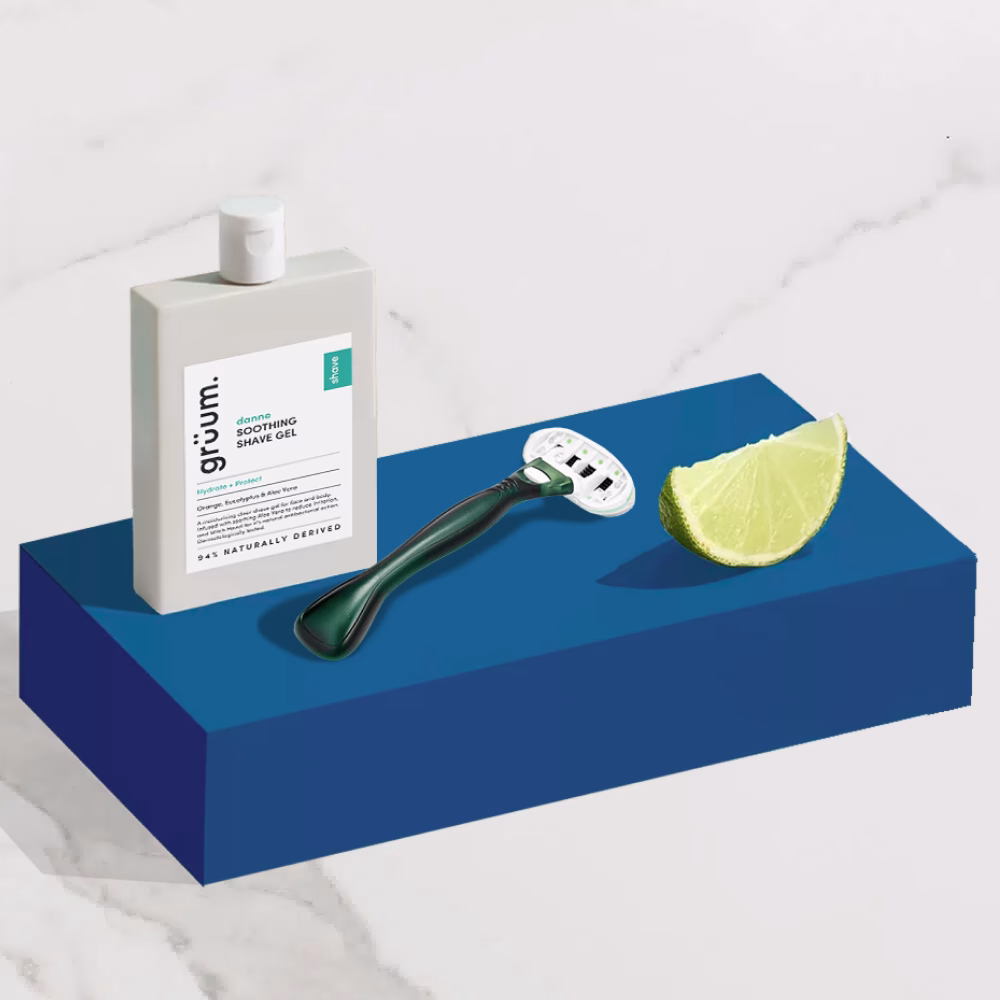 Shave gel, razor, lime on blue block.