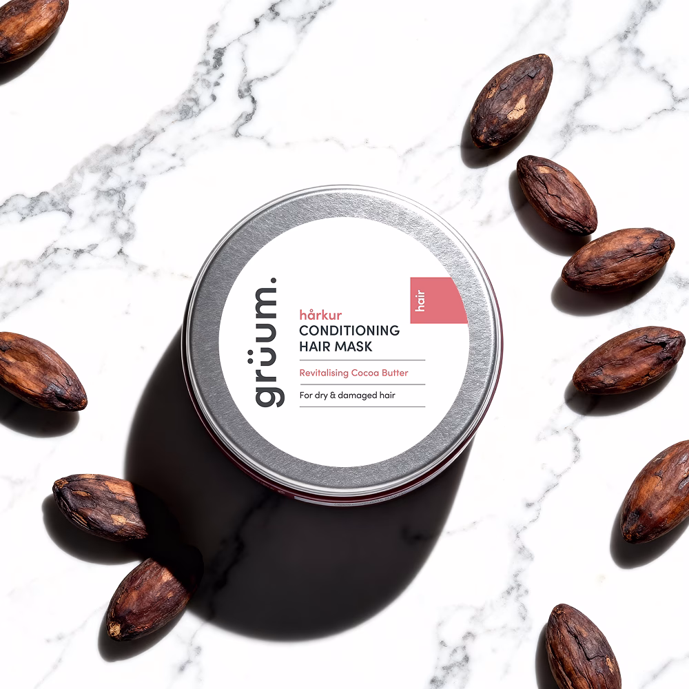 Hair mask tin with cocoa beans.