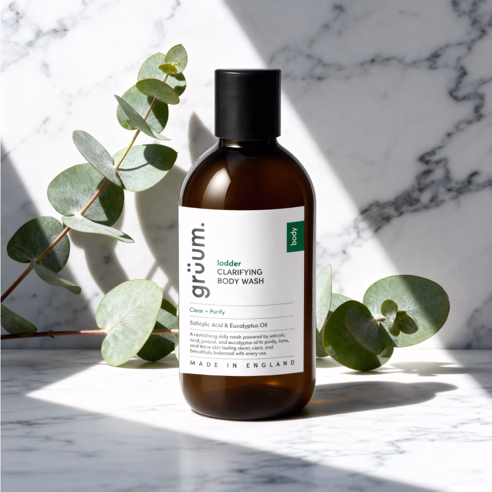 Body wash on marble with leaves.