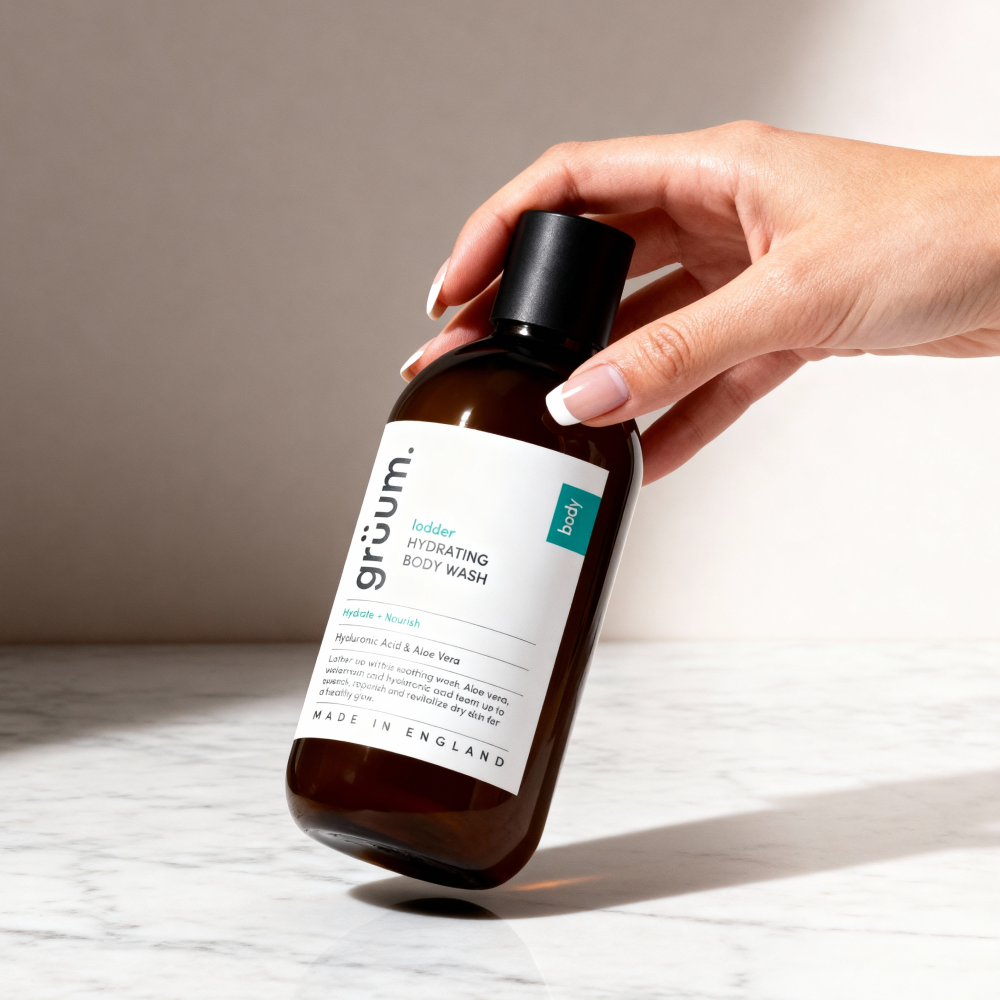 Hand holding hydrating body wash bottle.