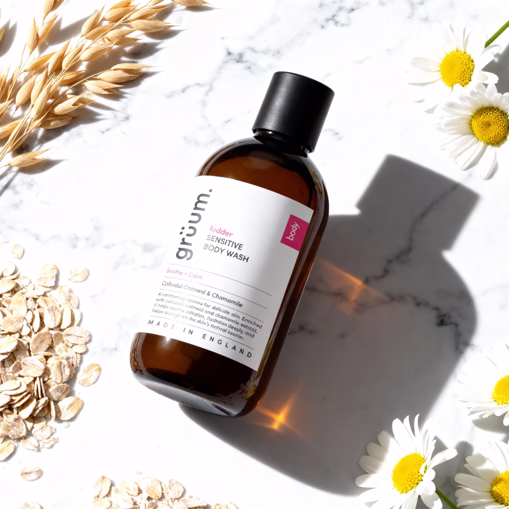 Body wash surrounded by oats and flowers.