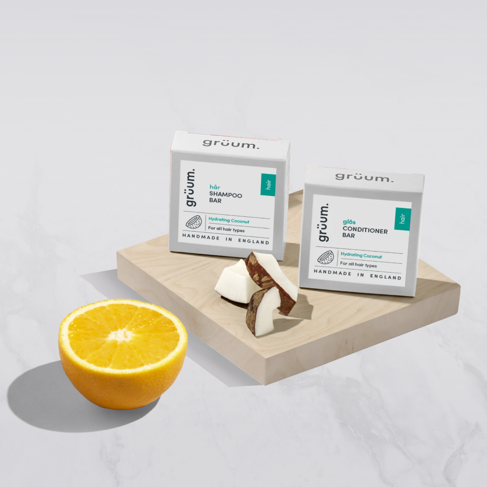 Shampoo and conditioner bars with an orange.