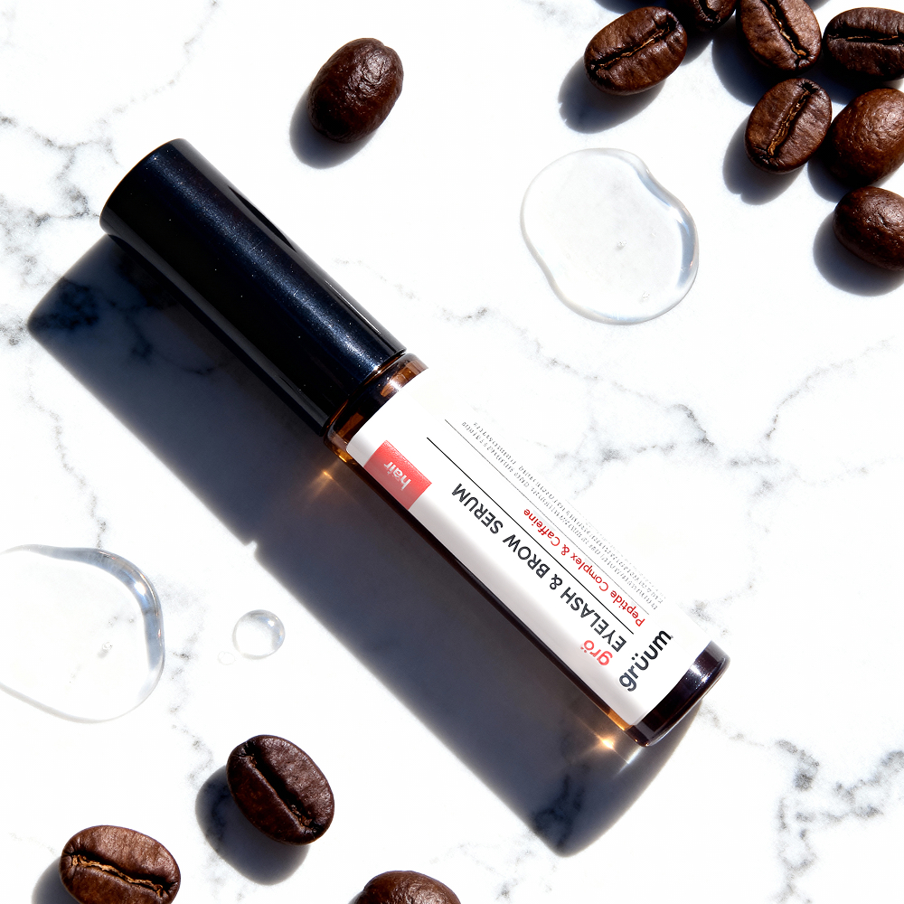 Serum with coffee beans on marble
