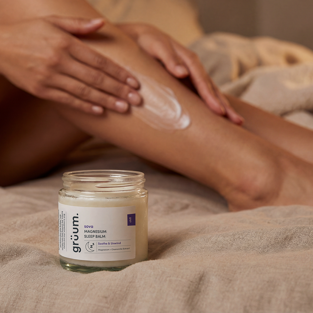 Person applying balm on leg.