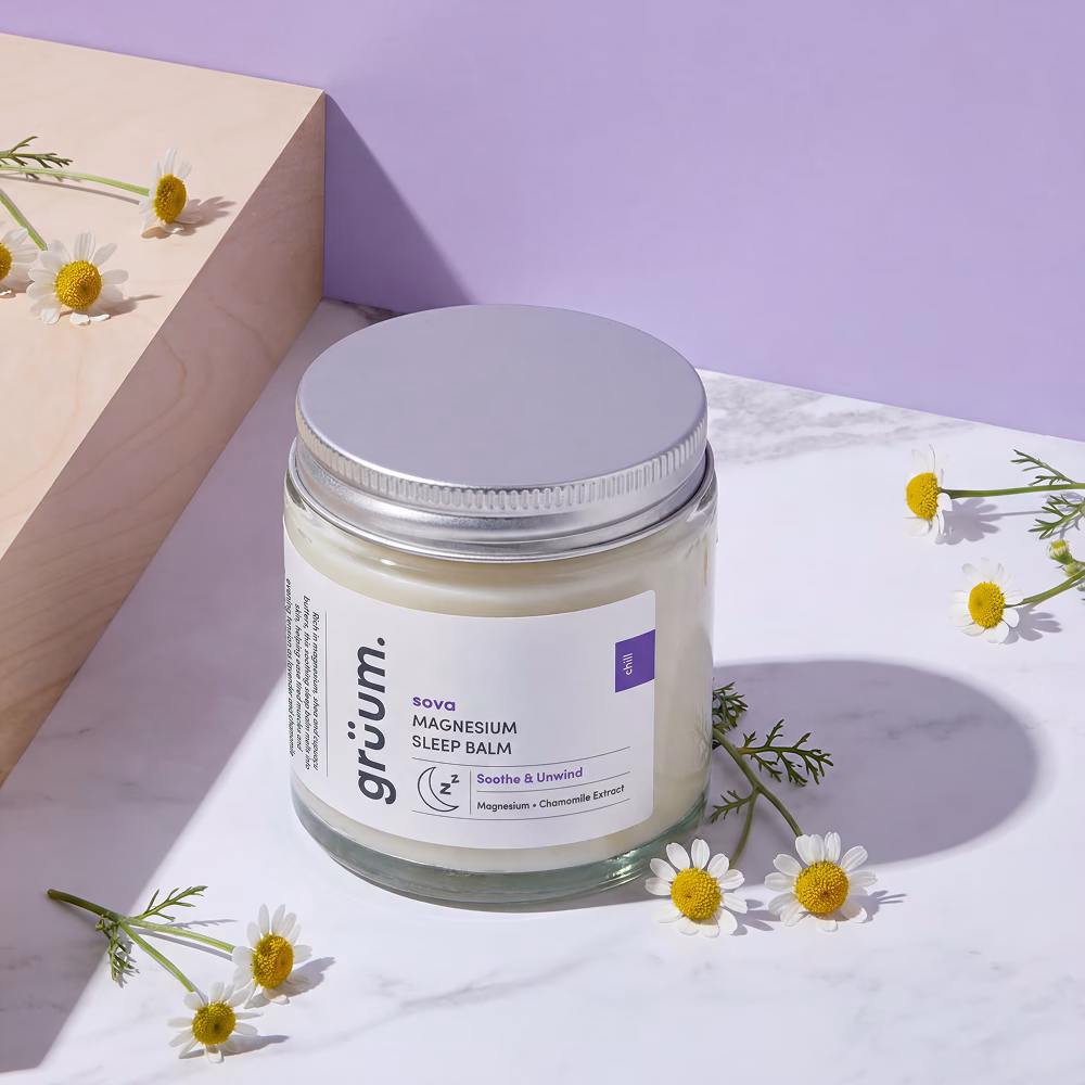 Magnesium sleep balm jar with flowers.