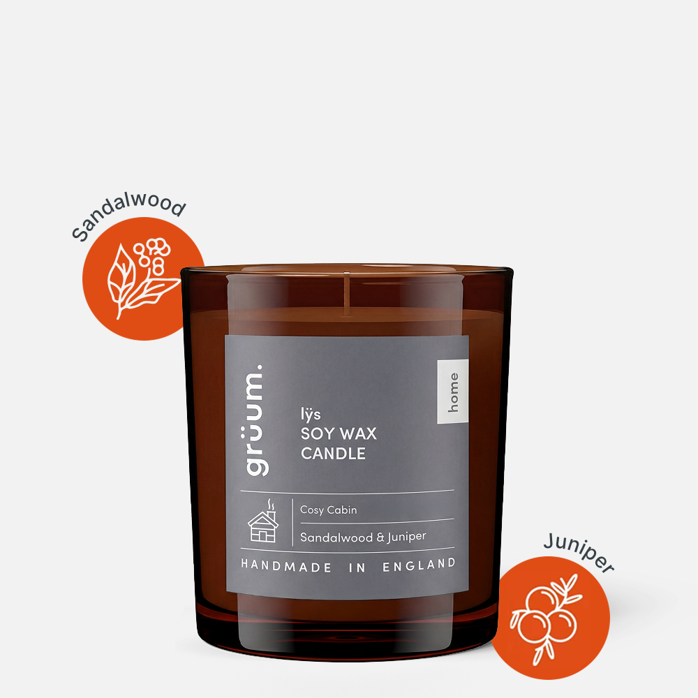 Brown soy wax candle with labels.