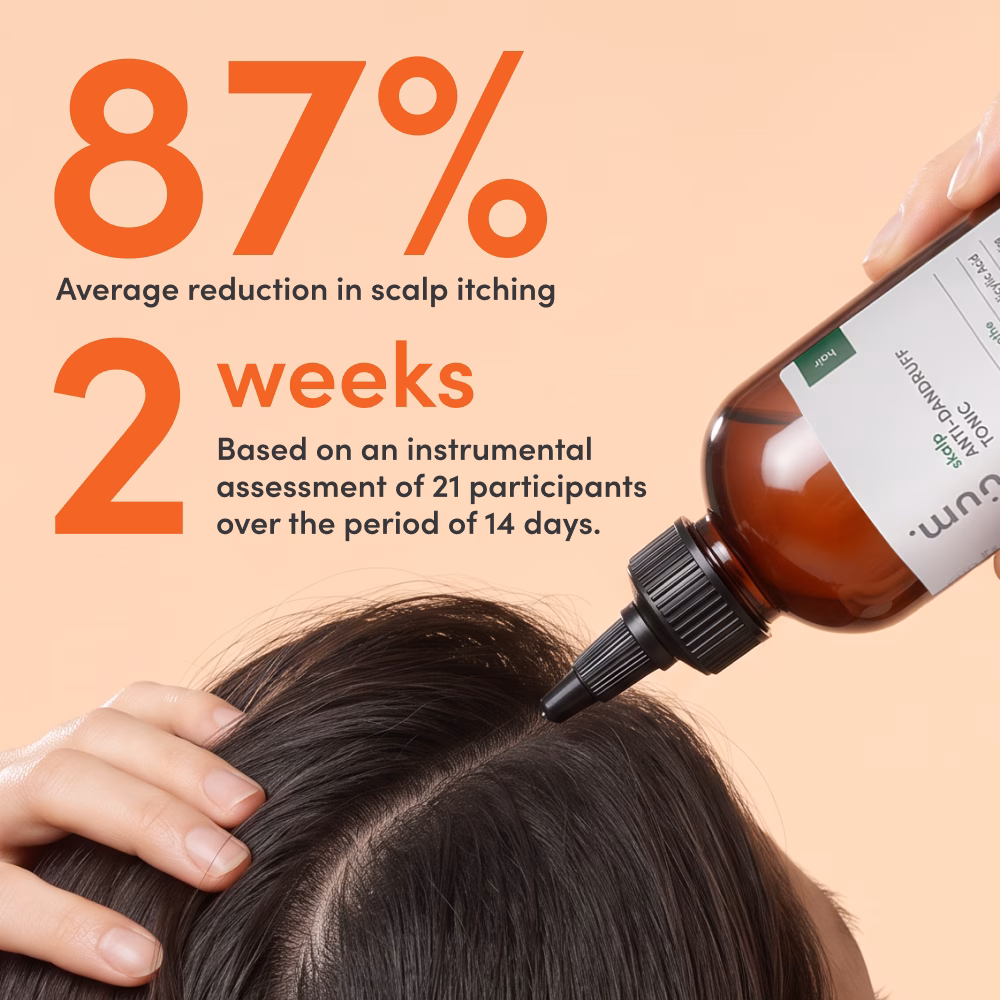 Bottle applying scalp treatment to a parted head